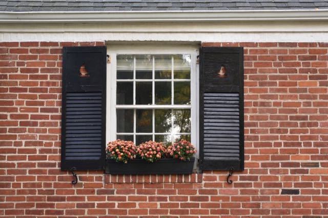 Boat cut outs in the shutters add a whimsical touch to the windows. Photo credit: Deb Cohen