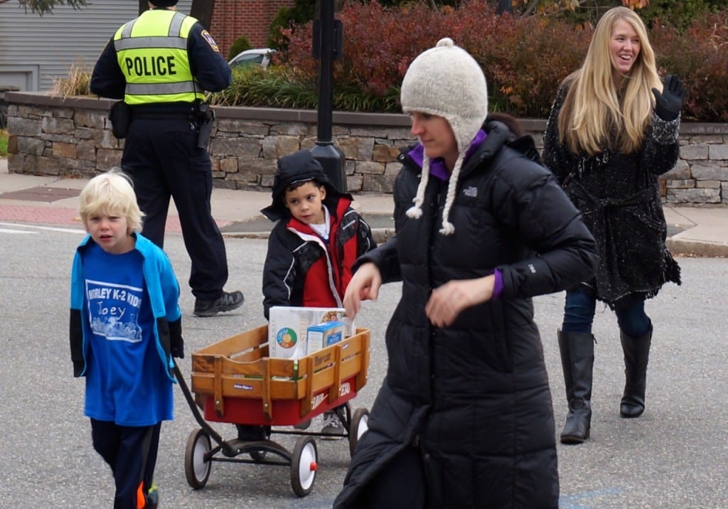 Morley second-grader Joey Fritz (left) pulls his red wagon across Raymond Road en route to West Hartford Town Hall. Morley Red Wagon Food Drive, Nov. 18, 2015. Photo credit: Ronni Newton