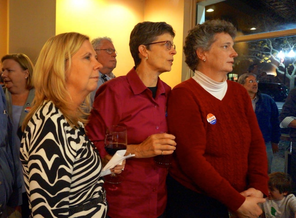 (From left) Town Clerk Essie Labrot, Tracey Wilson, and State Sen. Beth Bye listen to victory speeches Tuesday night at Democratic headquarters. Photo credit: Ronni Newton