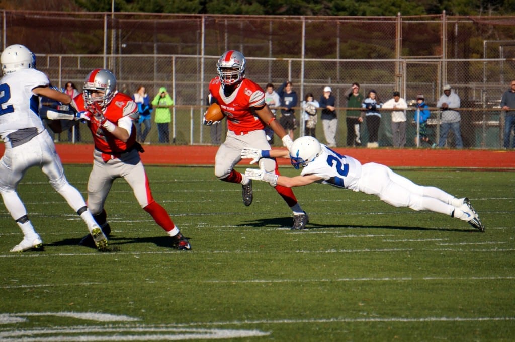 Hall's Christian Lund dives but can't stop Conard's Nate Richam. Annual Conard vs. Hall West Hartford Mayor's Cup football game. Nov. 21, 2015. Photo credit: Ronni Newton