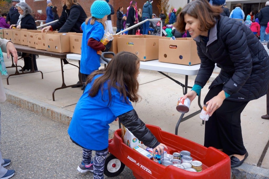 Suzanne Oslander (right) helps students empty their wagons outside West Hartford Town Hall. Morley Red Wagon Food Drive, Nov. 18, 2015. Photo credit: Ronni Newton