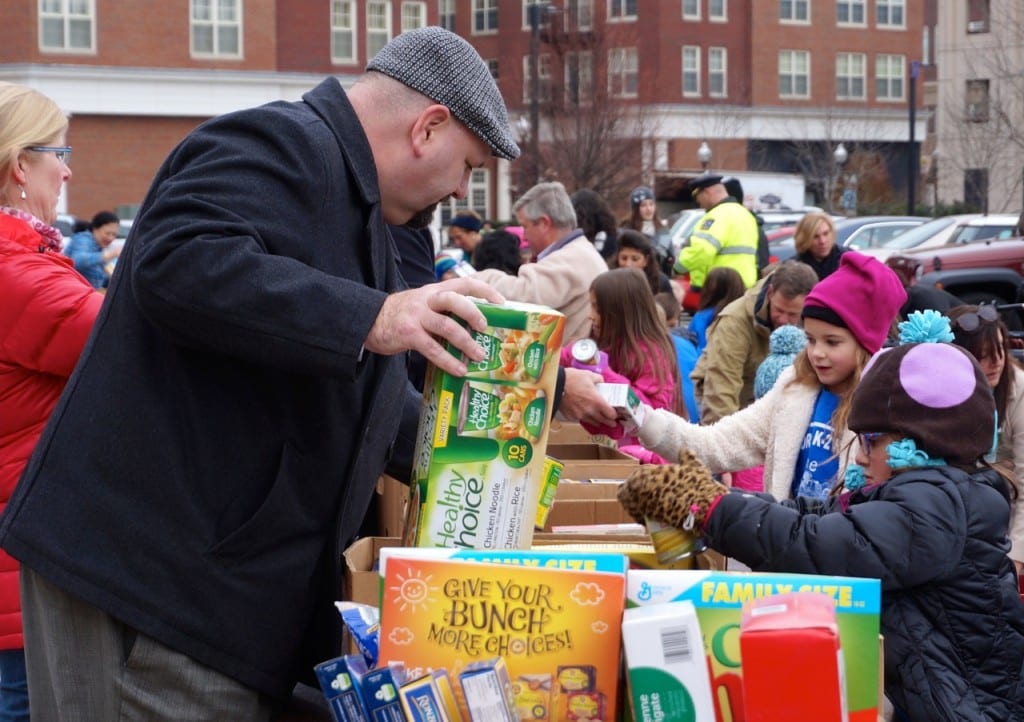 West Hartford Superintendent of Schools Tom Moore helps sort food delivered by the Morley students. Morley Red Wagon Food Drive, Nov. 18, 2015. Photo credit: Ronni Newton