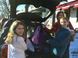 L-R: Jessica Callahan of Enfield, along with Lyndsey and Loralyn Callahan of Newington, donated warm winter gear to the New Country “Stuff a MINI to the Max” campaign when it rolled into West Hartford Center last year. Donations of warm winter clothing can be dropped off at West Hartford Center on Dec. 19 and 20. Submitted photo
