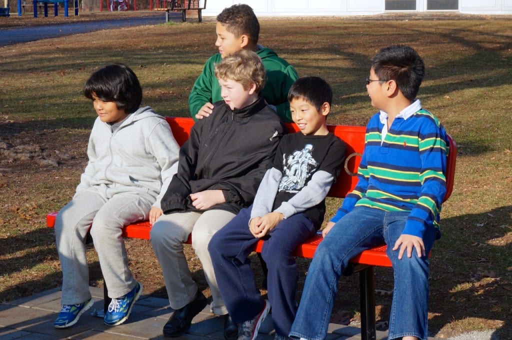 Wolcott Elementary School students test out the new buddy bench on Human Rights Day. Photo credit: Ronni Newton
