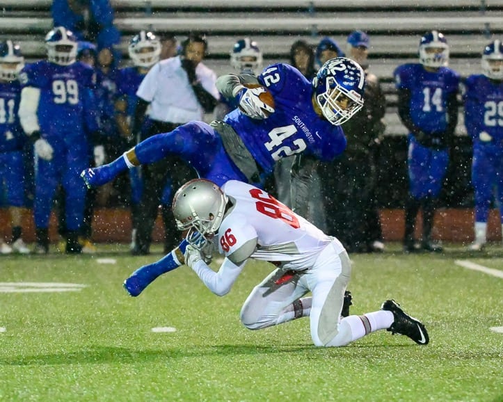 Conard's Ian Gearty pulls down Southington's Alessio Diana. Photo credit: Andew Stabnick, Low Tide Photography