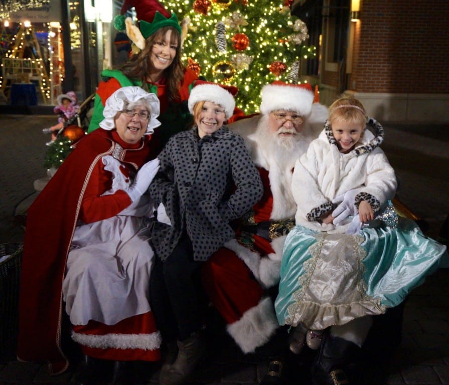 Allie Sullivan (left) and her sister Kiley Sullivan sit with Santa and Mrs. Claus in Blue Back Square. West Hartford Holiday Stroll, Dec. 3, 2015. Photo credit: Ronni Newton
