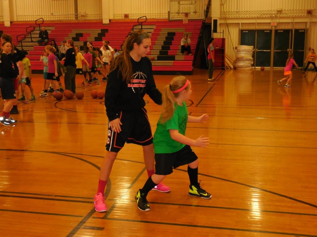 Conard sophomore Delaney Connors helps teach proper defensive sliding technique. Submitted photo