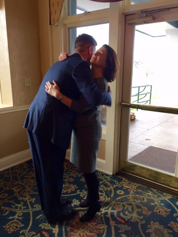 Mayor Scott Slifka hugs his wife, Noelle, after making the announcement that he will resign this spring. Photo credit: Ronni Newton