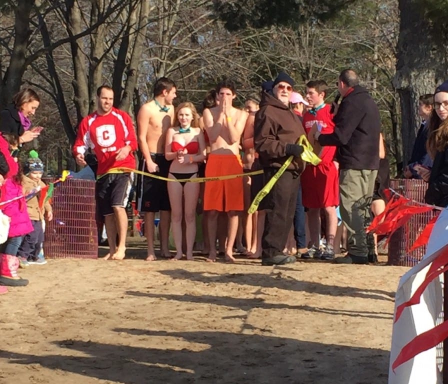 The Conard team of Penguin Plungers prepares to charge into Dunning Lake at Winding Trails as part of a fundraiser for Special Olympics Connecticut. Submitted photo