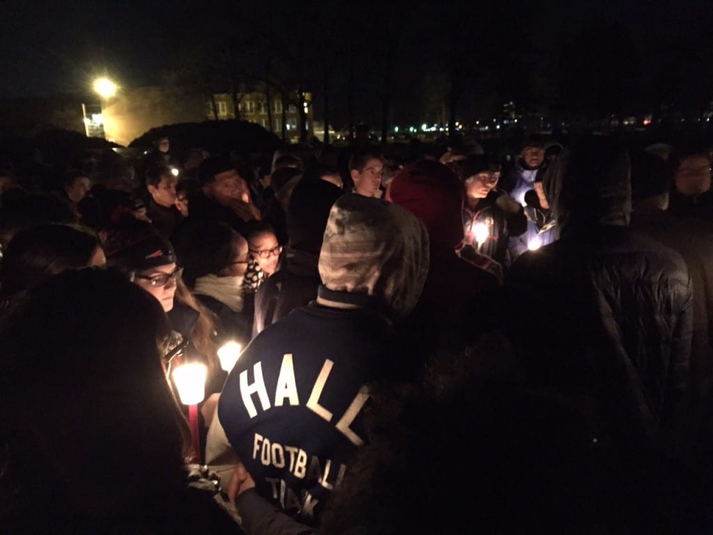 Friends and family, including numerous football players from crosstown rival Hall High School, attend a candle vigil for Jonathan Douglin at Sterling Field in West Hartford on Jan. 6, 2016. Photo credit: Ronni Newton