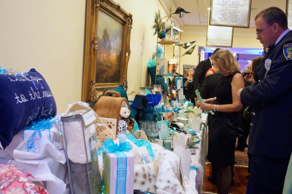 Checking out the basket raffle. 17th annual Children's Charity Ball, Jan. 23, 2016. Photo credit: Ronni Newton
