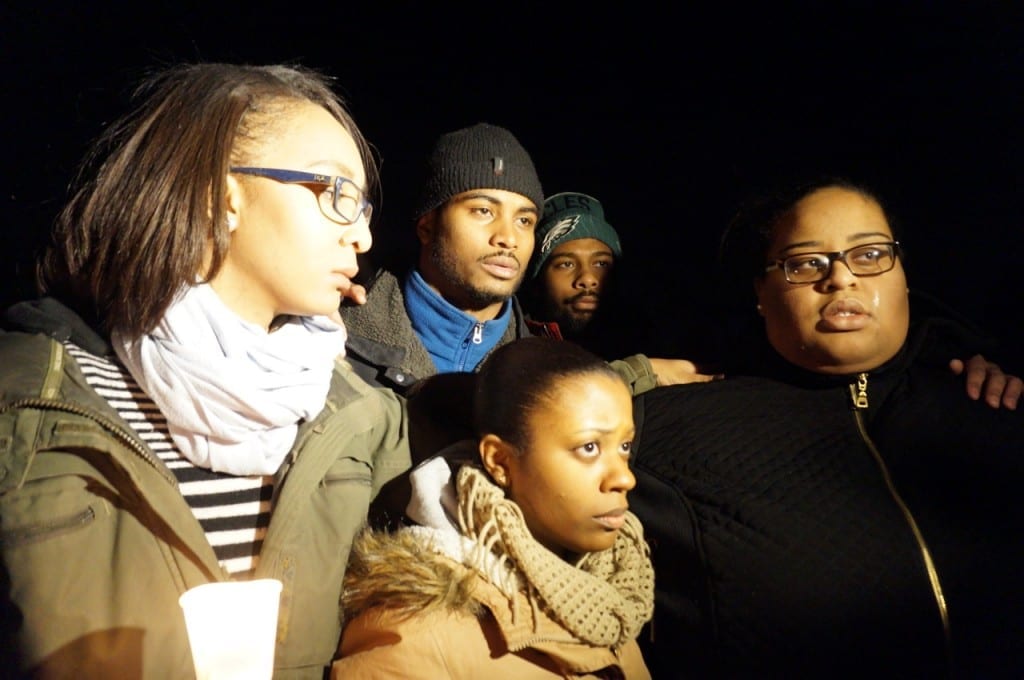 Matt Douglin (back row, second from left), Ricky Douglin (back row, right), and Nicole Douglin (front row, at right) speak about their brother at the vigil. Photo credit: Ronni Newton