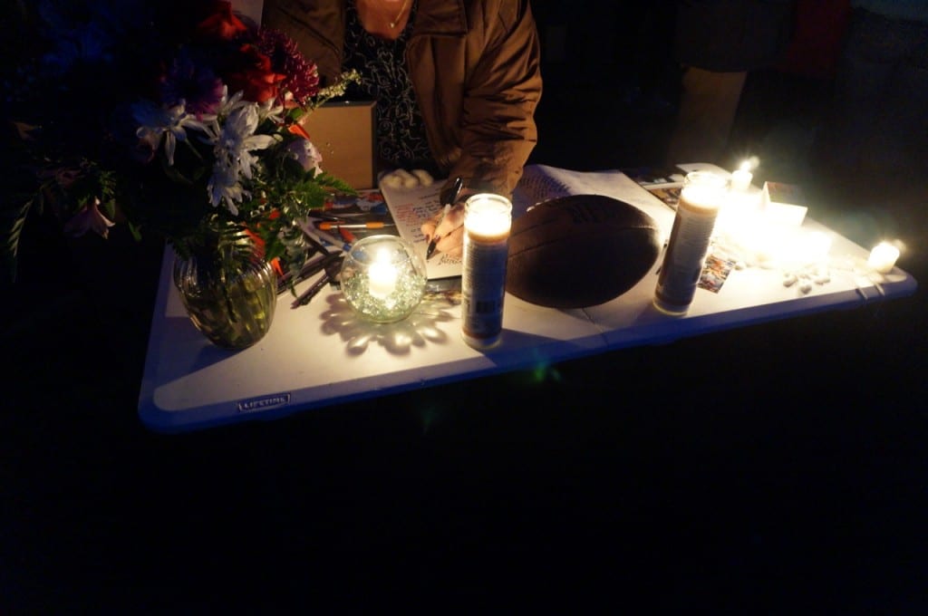 Friends and family sign a memory book at the vigil at Sterling Field on Jan. 6, 2016. Photo credit: Ronni Newton