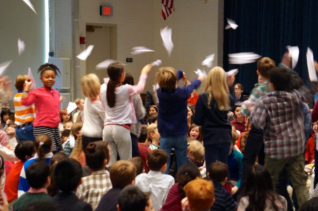 Fourth graders release paper airplanes inscribed with their favorite words about Renbrook. Photo credit: Ronni Newton