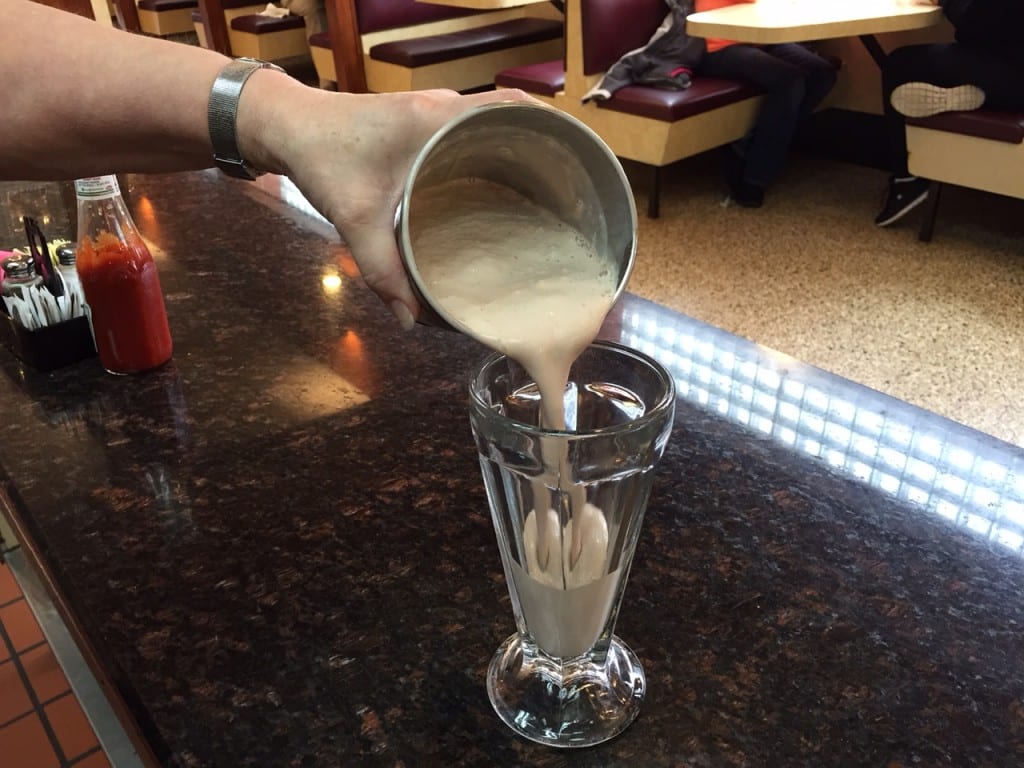 The finished product, poured from a stainless steel cup into an old-fashioned milkshake soda glass, is worth every calorie. Photo credit: Ronni Newton