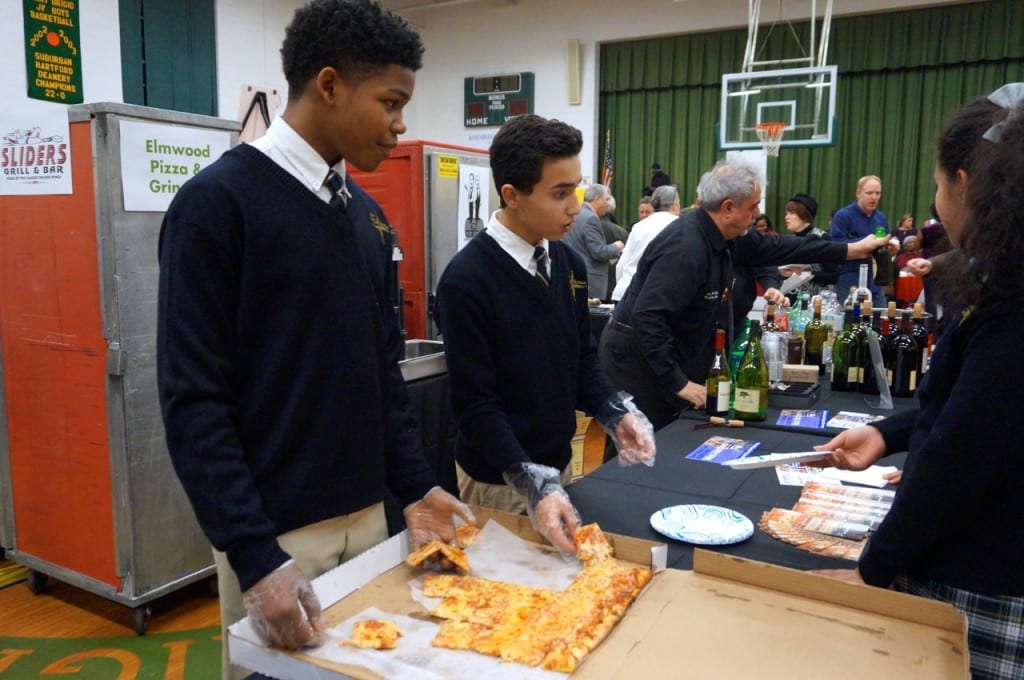 Students from St. Brigid School help service pizza from Elmwood Pizza. Taste of Elmwood. Feb. 4, 2016. Photo credit: Ronni Newton