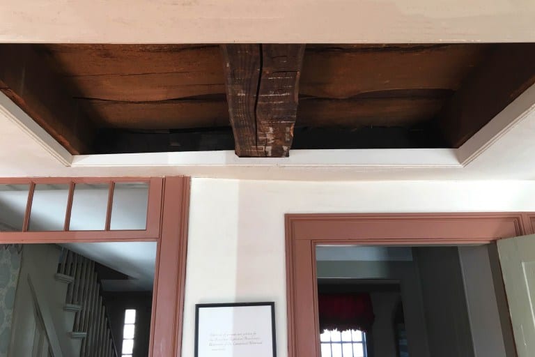 A cutout in the kitchen lets visitors see a portion of the home's traditional post and beam construction. Photo credit: Deb Cohen