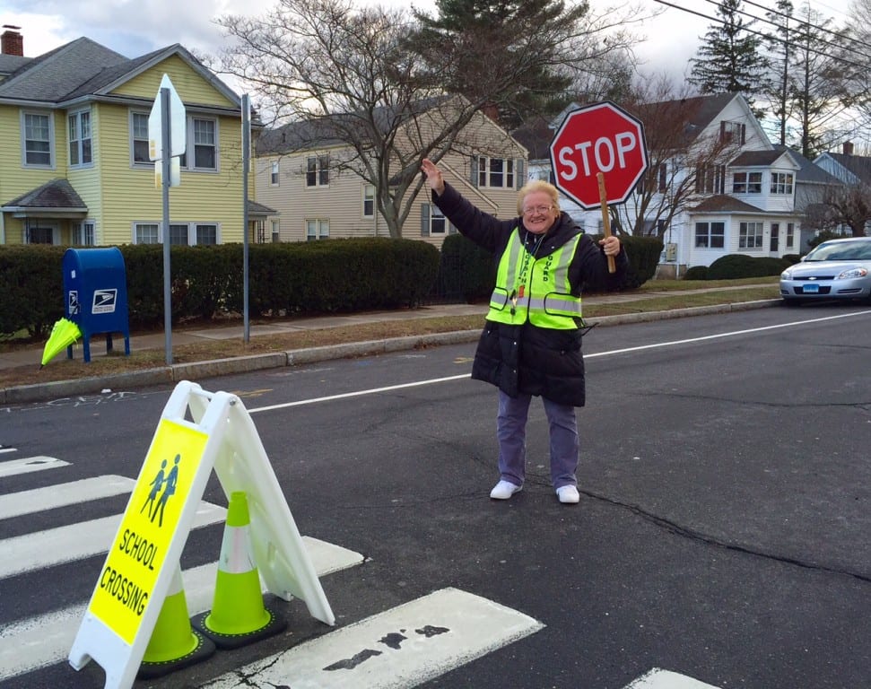 West Hartford crossing guard Marie Templeton has been manning the intersection of South Quaker Lane and Seymour Avenue for three years. She is known for waving at everyone, and recently has been called a hero. Photo credit: Ronni Newton
