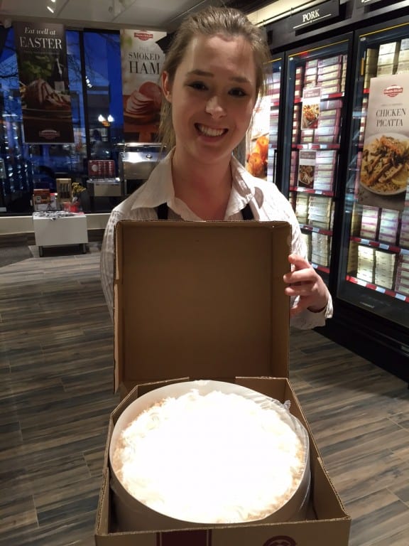 Omaha Steaks employee Nicole Kosakowski shows off a coconut cream cake. Photo credit: Ronni Newton