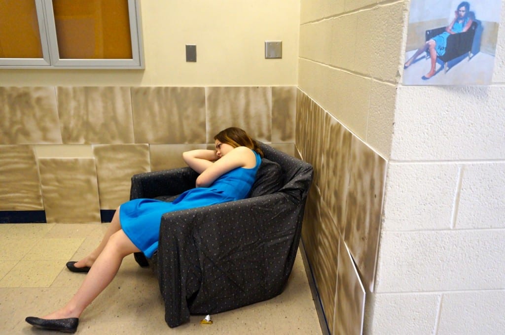 Students paused outside a scene in the corner of a hallway where this girl was slumped in a chair just like the girl in the painting taped to the wall. Photo credit: Ronni Newton