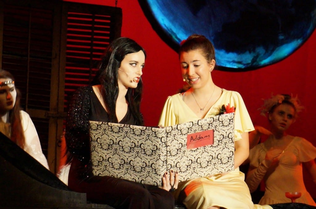 Morticia shares family history with Alice Beinke (Emma Damokosh). Conard High School Musical Productions presents 'The Addams Family.' Photo credit: Ronni Newton