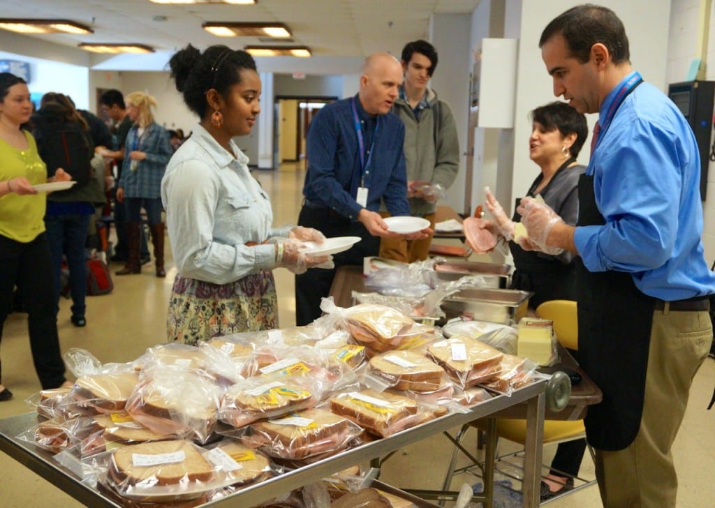 Principal Dan Zittoun (right) and Assistant Principal Shelley Solomon (second from right) preside over sandwich-making. Do Something Day. Hall High School. March 9, 2016. Photo credit: Ronni Newton