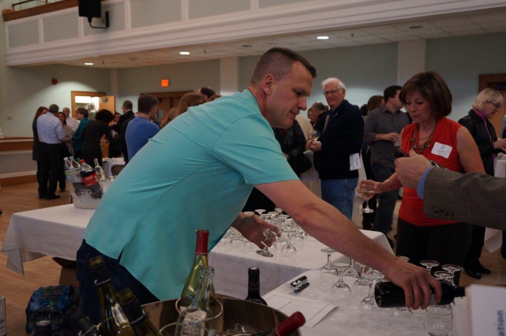 Martin Woods serves wine to guests at West Hartford's Cookin', April 2, 2016. Photo credit: Ronni Newton