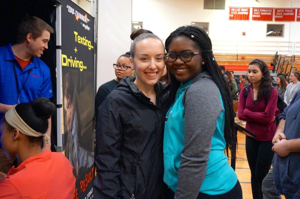 Junior Monet Carter (right) said she doesn't have her license yet but wanted to learn how it feels to text and drive. She and junior Michelle Pettigrew (left) both signed the safe driving pledge. Photo credit: Ronni Newton