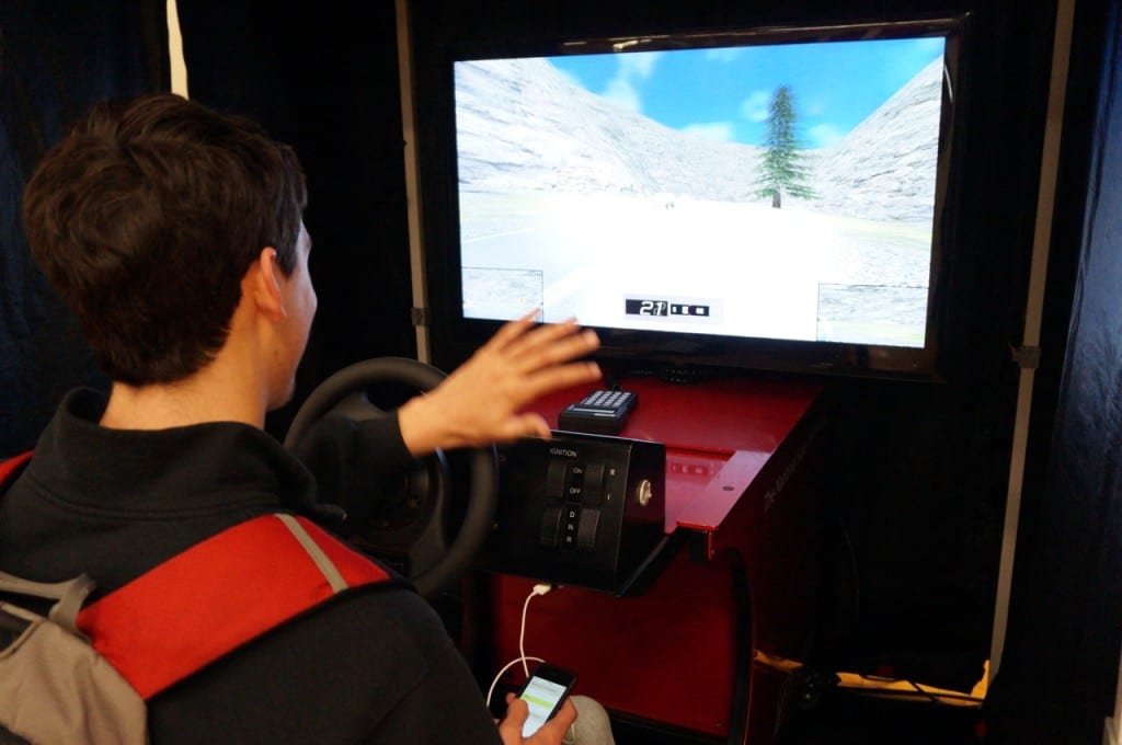 Conard senior Jordan Fongemie attempts to stay on the road while texting in a distracted driving simulation. Photo credit: Ronni Newton