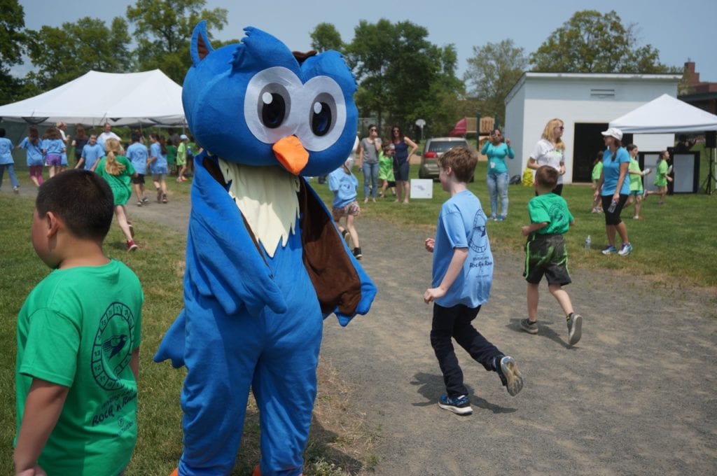 Flash the mascot high-fives participants in the Whiting Lane Rock 'n Run. May 20, 2016. Photo credit: Ronni Newton