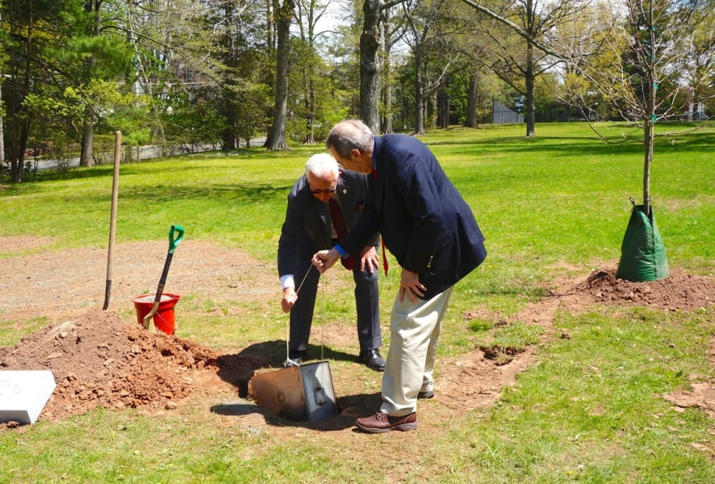 Old Guard member Peter Tiernan (left) and member Lucien Dallaire bury a time capsule in West Hartford's Fernridge Park at a ceremony Tuesday. Photo credit: Ronni Newton