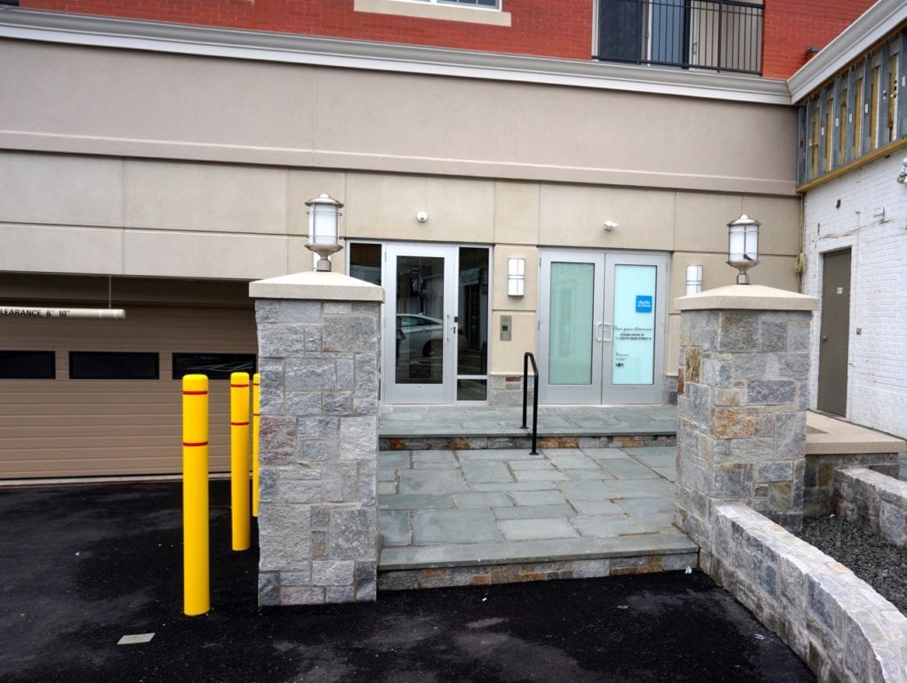 The entrance from the rear parking lot includes a stone patio and heated walkway. Photo credit: Ronni Newton