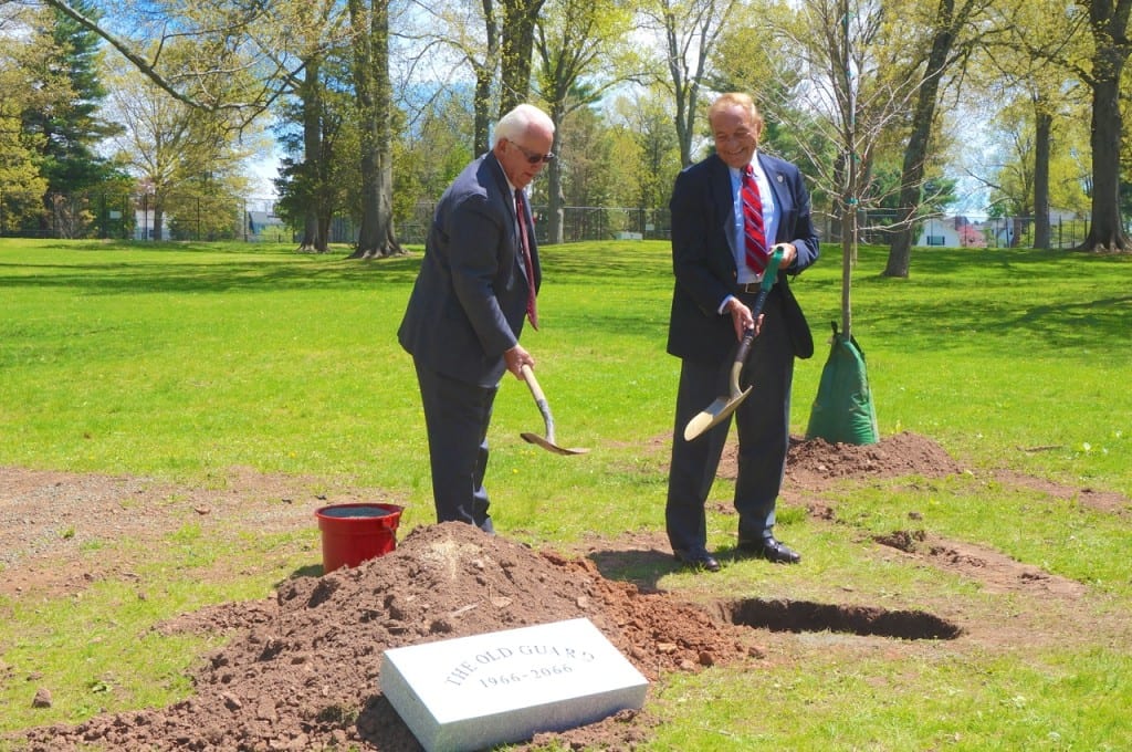 Old Guard VP Jeff Lee (left) and member Lucien Dallaire shovel dirt into the hole to complete the burying of the time capsule. Photo credit: Ronni Newton
