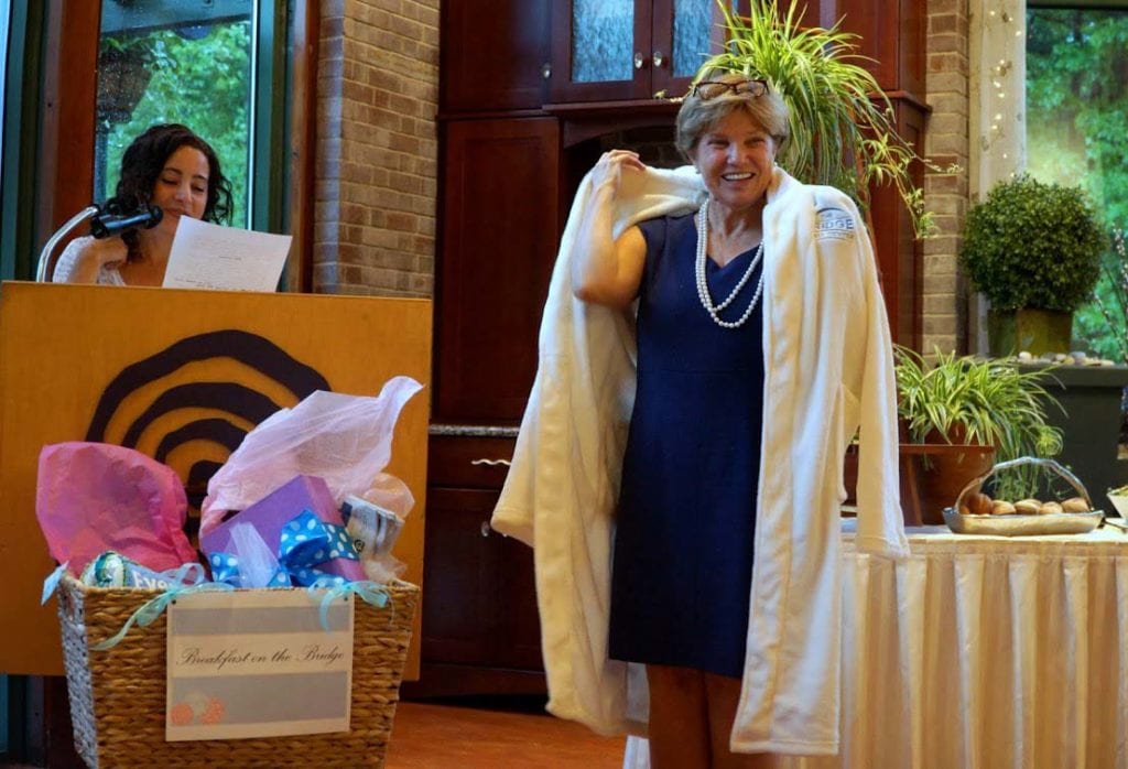 Nancy Hunt presents Judy Bierly with a bathrobe. Photo credit: Rebecca Holmes