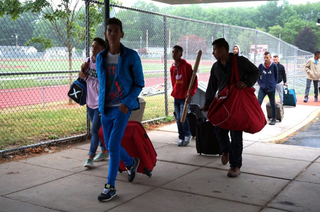 Team Cuba files into the Conard locker room to shower after their 36-hour journey. Photo credit: Ronni Newton