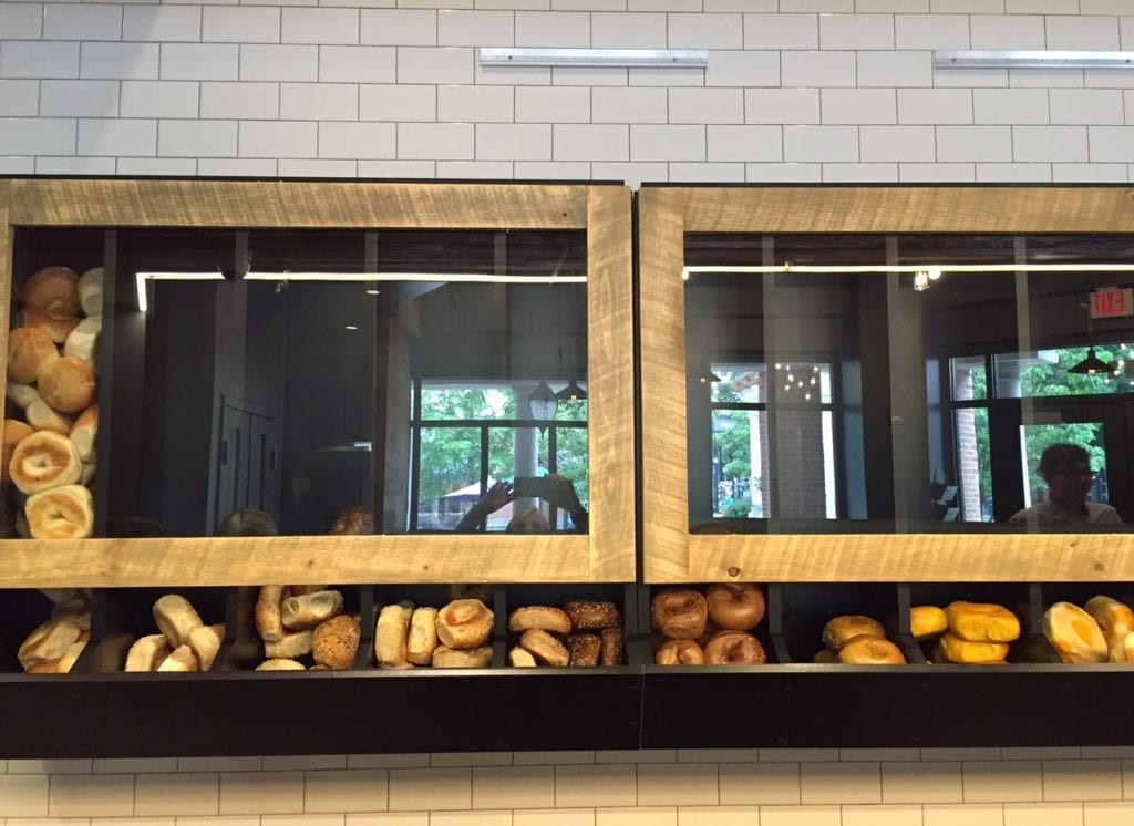 Customized bagel racks cover the wall behind the counter at Goldberg's Gourmet. Photo credit: Ronni Newton