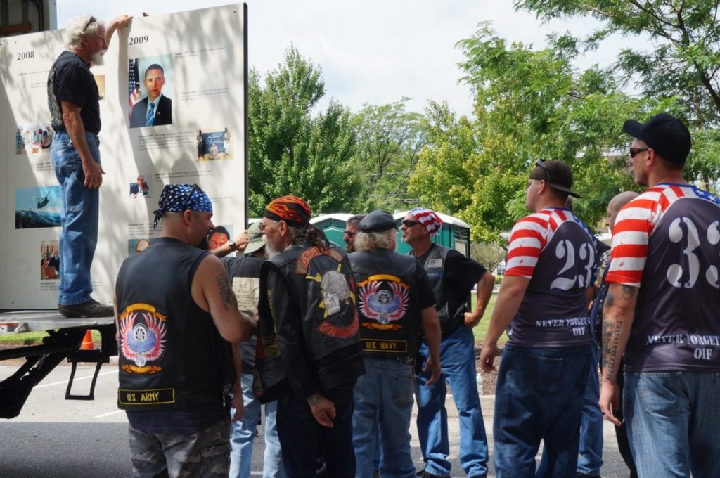 Veterans and other supporters, many from the Valhalla Motorcycle Club, help unload the memorial from a truck rented after the official truck broke down. Photo credit: Ronni Newton