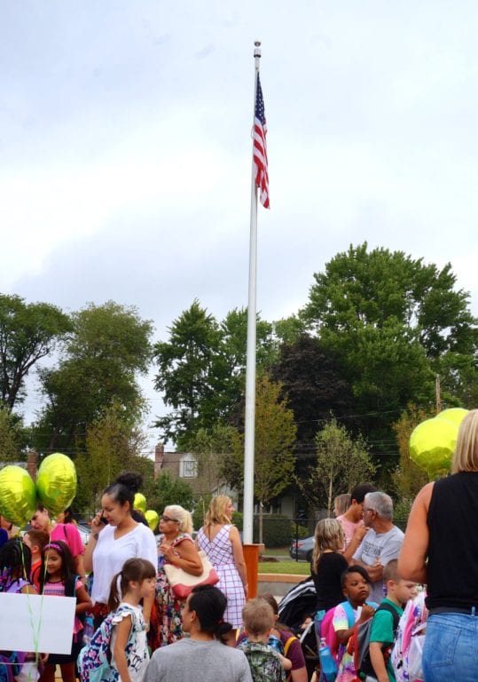 Families gather around the flagpole at Charter Oak International Academy. Aug. 31, 2016. Photo credit: Ronni Newton