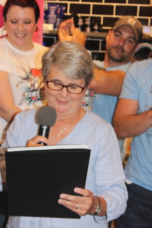 West Hartford Town Council member Beth Kerrigan reads a Proclamation by Mayor Shari Cantor to recognize Kiehl’s AIDS fundraising. PHoto credit: Julius Fabrini