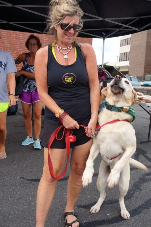 Buddy leaps for a treat as owner Patty Swanson holds onto the leash. Dog Days of Summer at the Farmers' Market at Bishops Corner. Aug. 6, 2016. Photo credit: Ronni Newton