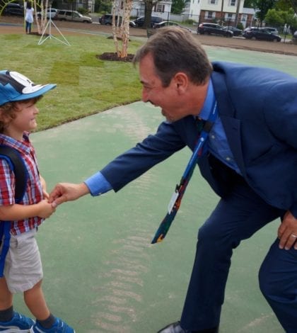 juan melian greets student