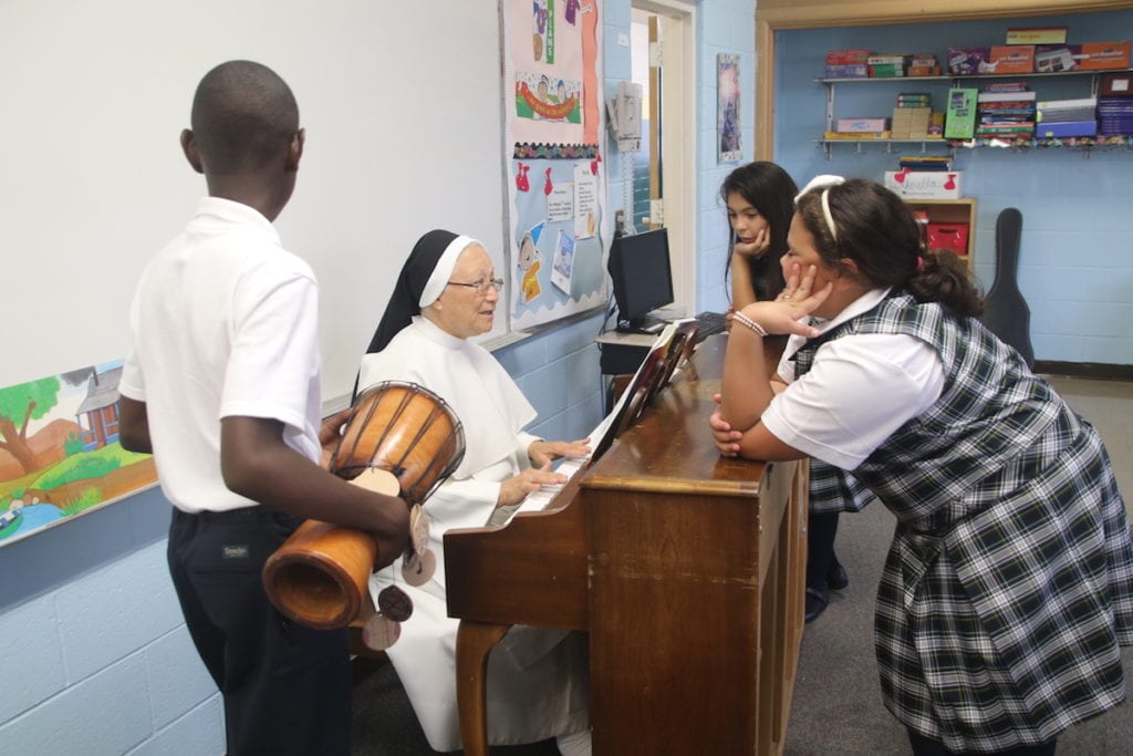 Sister Esther Ortiz Elvarado with students in the Music Room at St. Brigid-St. Augustine. Photo credit: Dylan Carneiro