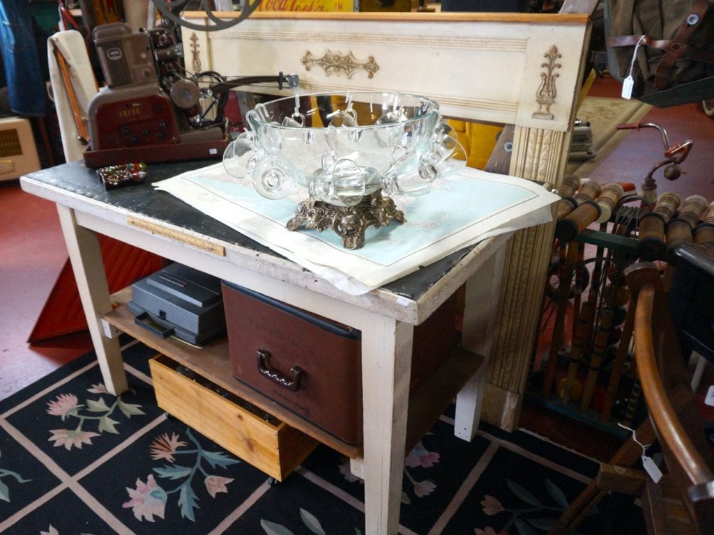 The white table was salvaged from a girl's reformatory school in Massachusetts. Old Crow Vintage sells vintage, antique, and repurposed items. Photo credit: Ronni Newton