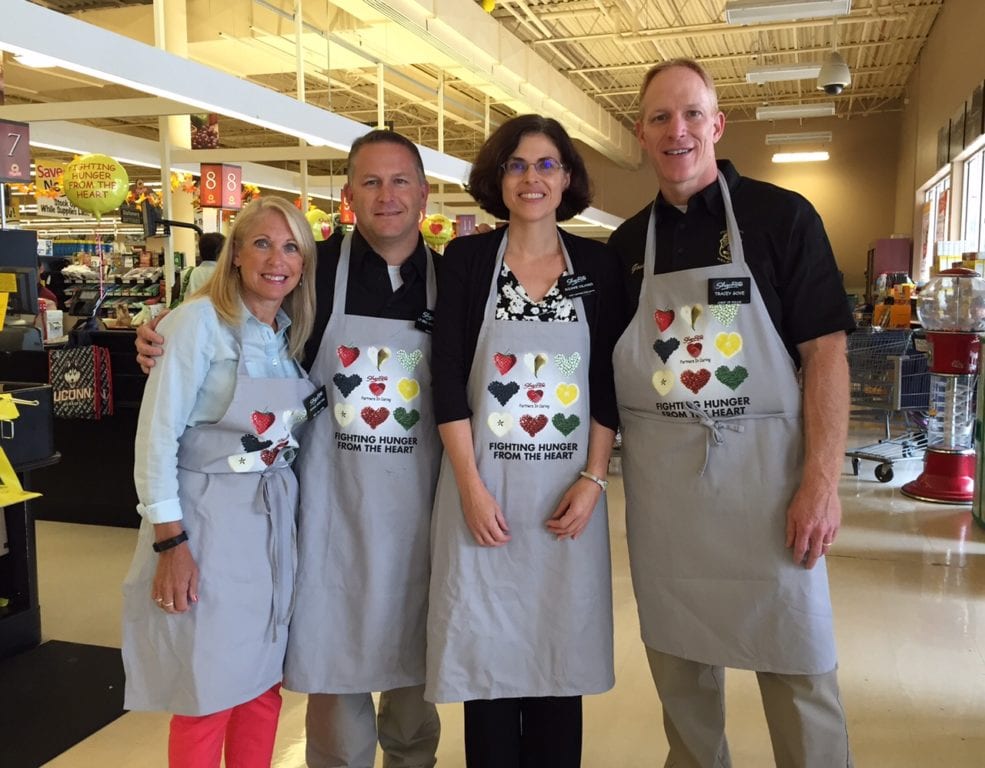 With fellow honorary grocery baggers (from left) Eric Rocheleau, Suzanne Oslander, Tracey Gove.
