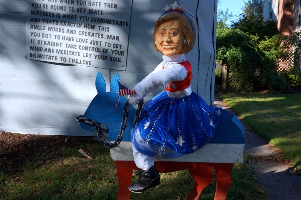 Hillary Clinton appears in the display wearing a tiara and riding a donkey, that she holds by a chain. Photo credit: Ronni Newton