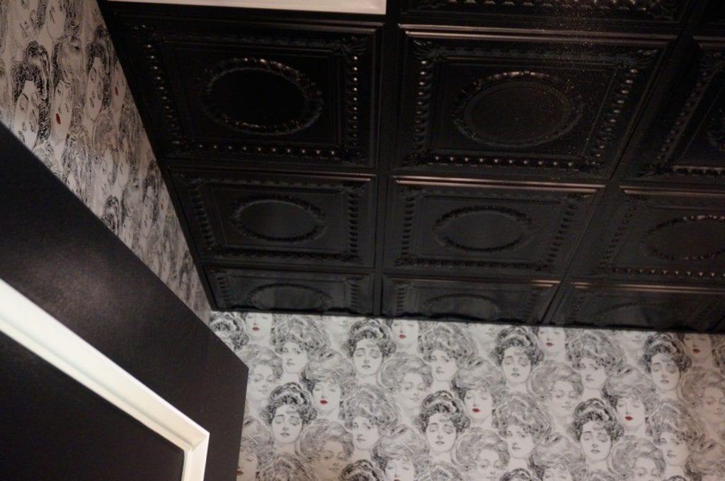 Black and white wallpaper sets off the black tile in the ladies room at Noble & Co. Photo credit: Ronni Newton