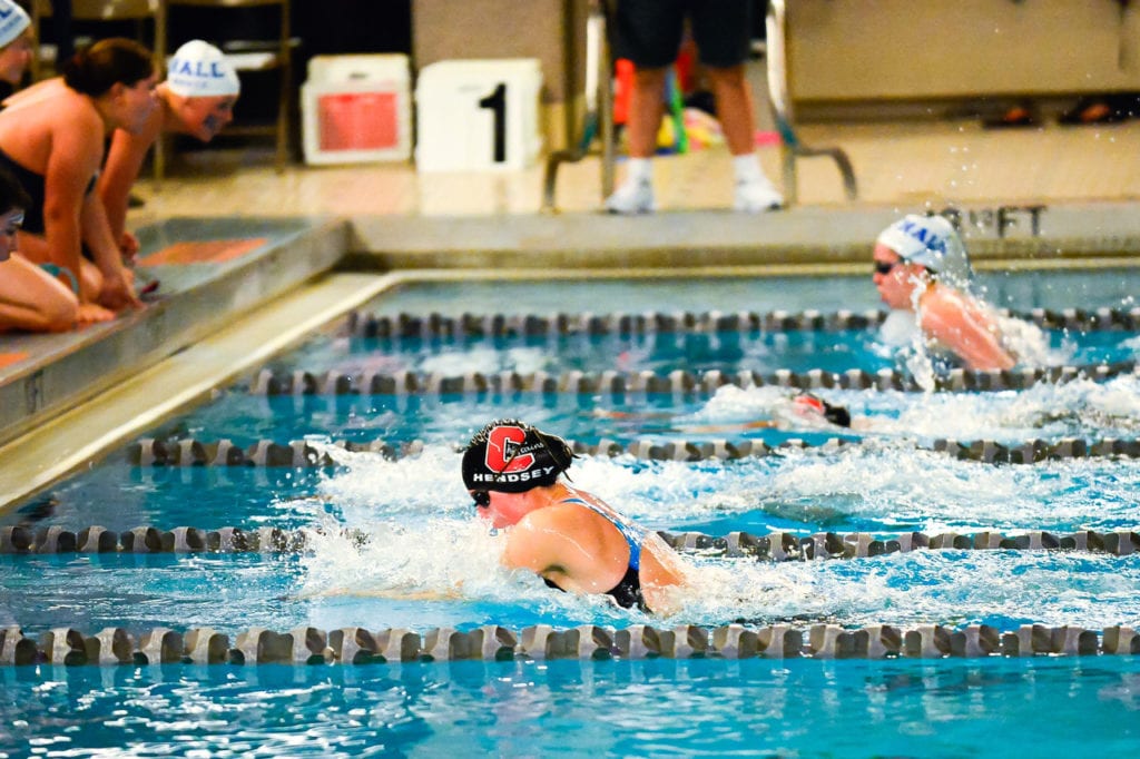 Becca Hendsey wins the 100 breast stroke. Photo credit: Andy Stabnick, LowTide Photography