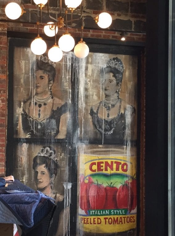 Queen Margherita of Savoy and the Cento Tomato label form an eclectic collage in the corner of Savoy Pizzeria and Craft Bar. Photo credit: Ronni Newton