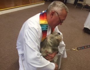 Scarlett being blessed by Bob Hooper, rector of St. James's Episcopal Church. Photo credit: Ronni Newton