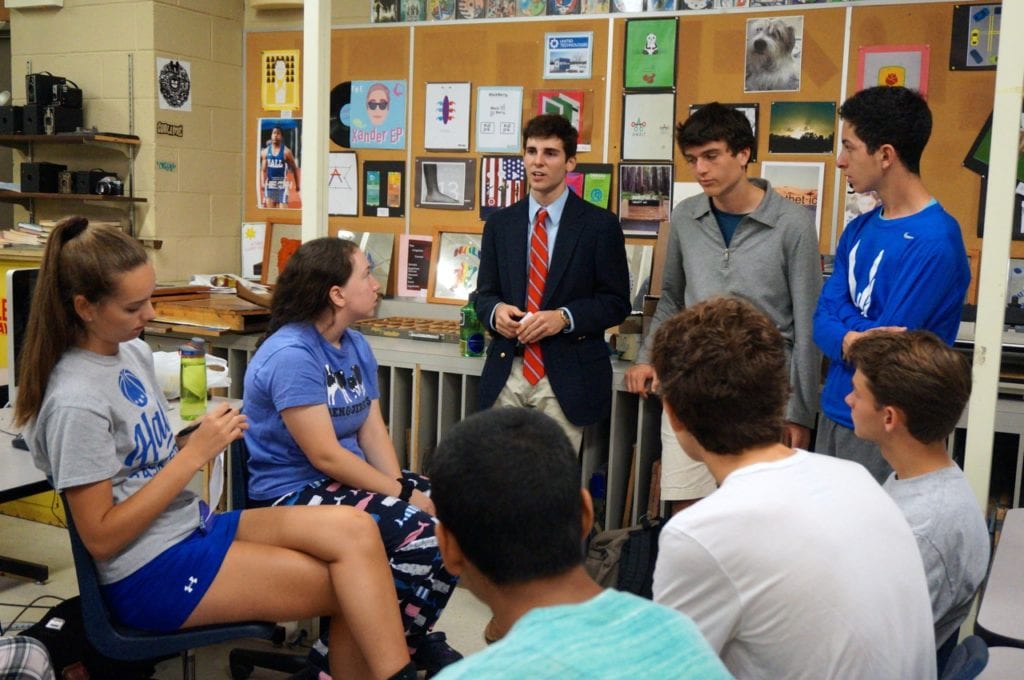 Hall student Sam Fiske (in red tie) brainstorms with a group of students about teen safe driving issues. Photo credit: Ronni Newton